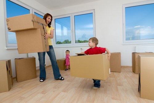 Removal team transporting furniture for a Westminster property move